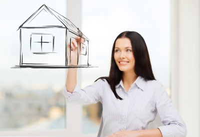 real estate, accomodation and technology concept - smiling woman drawing house on virtual screen